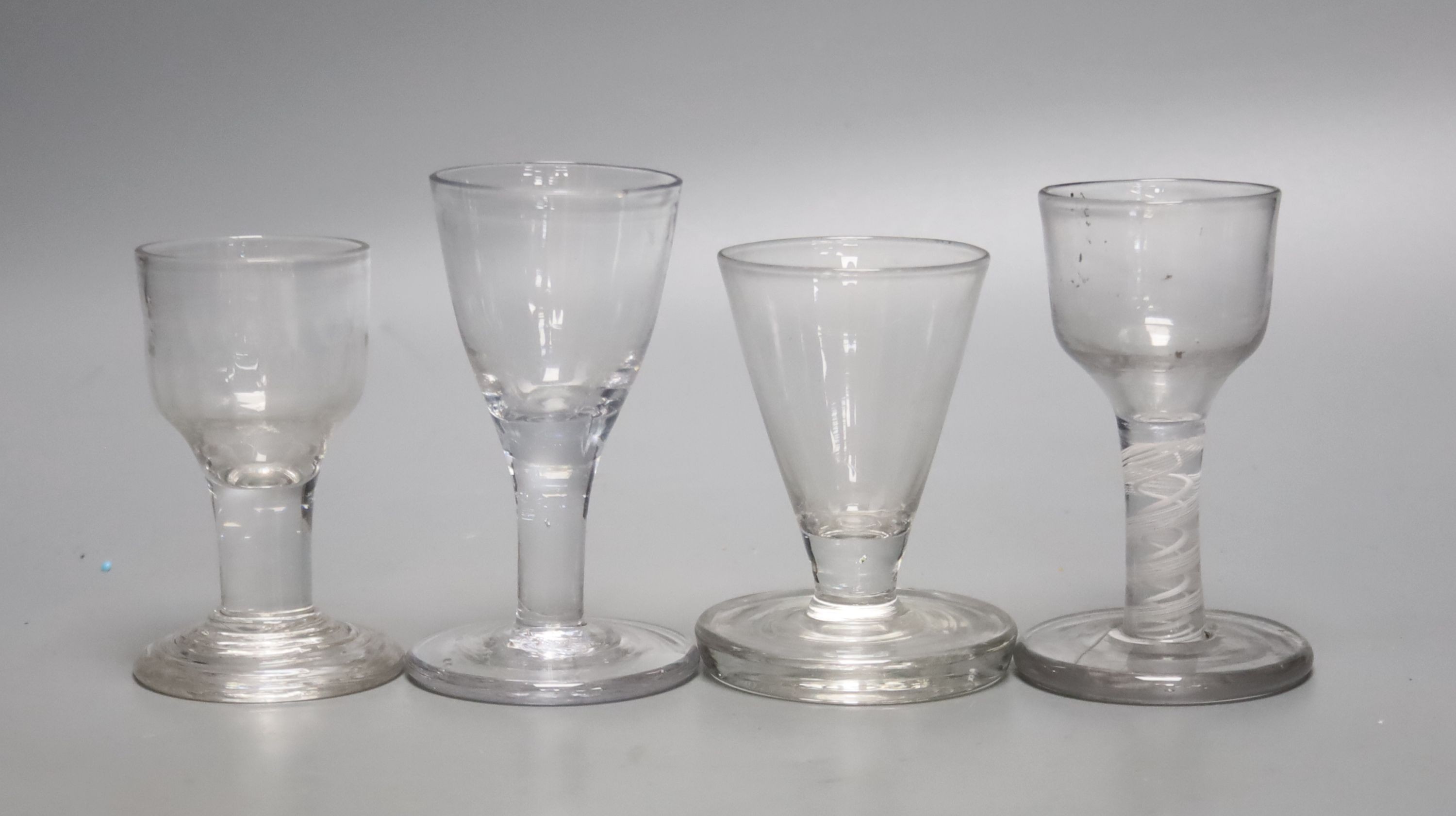 Four Georgian 'Toast Master' glasses, one with opaque twist stem, c.1760-80